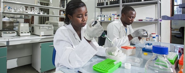 Lab techs conducting mosquito research in Tanzania.